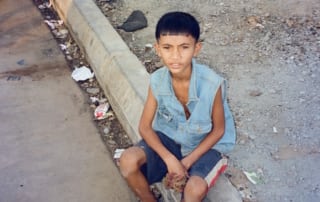 Boy by village slums